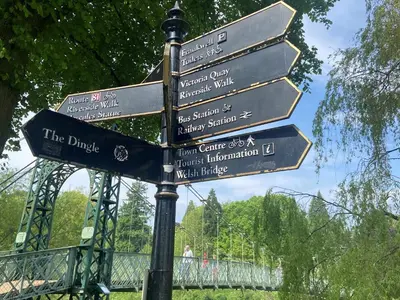 a street sign with directions to different attractions at Riverbank in Shrewsbury