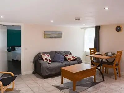 a living room with a couch and a table at The Dairy - Uk47471 in Llanerch-Aeron