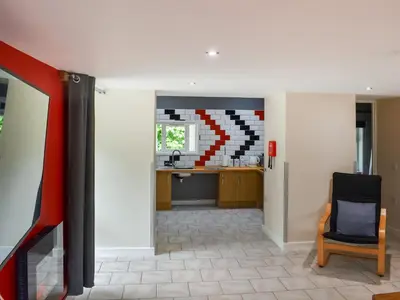 a living room with a table and a kitchen at The Dairy - Uk47471 in Llanerch-Aeron