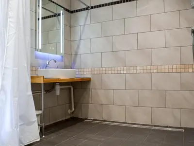 a bathroom with a sink and a mirror at The Dairy - Uk47471 in Llanerch-Aeron