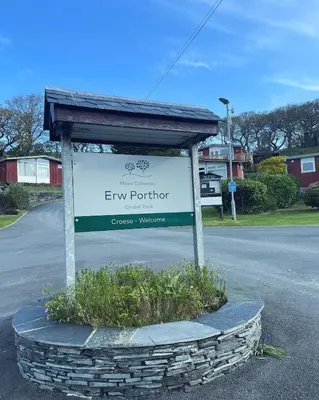 a sign for aevp potulator on a street at Cosy private Chalet in Tywyn