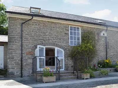 a brick house with a white door and a window at The Granary - Or3 in Henfynyw Upper