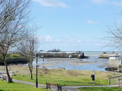 a marina with a bunch of boats in the water at The Cow Shed - Or5 in Henfynyw Upper