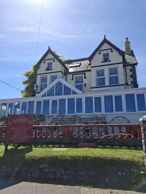 a large house with a sign in front of it at The Cambrian in New Quay