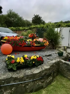 a bouquet of flowers on a stone wall at The Cambrian in New Quay