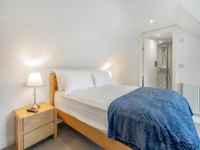 a bedroom with a bed and a lamp on a night stand at Orchard Barns - Uk47200 in Stapleton