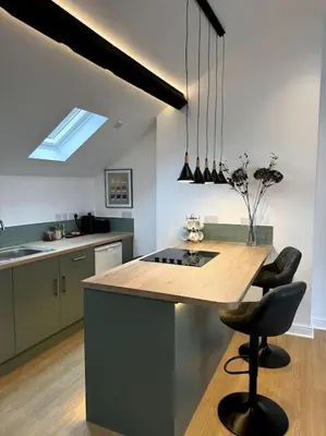 a kitchen with a large island with a counter top at Penny Red apartment in Kington in Kington