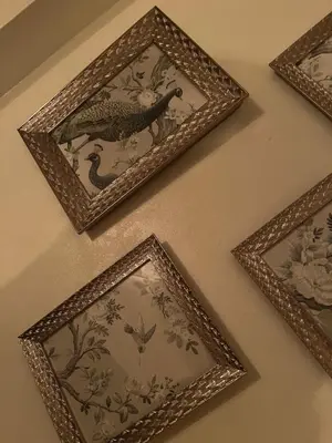 a group of framed pictures on a wall at The Bull Hotel in Ludlow