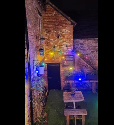 a room with a table and a brick building with lights at The Bull Hotel in Ludlow
