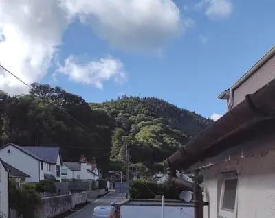 a view of a town with a mountain in the background at Castell Bach in Llangollen