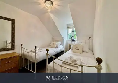 a bedroom with two beds and a mirror at 2 Bed Shrewsbury Apartment in Great Location in Shrewsbury