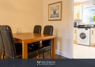 a dining room table with black chairs in a kitchen at 2 Bed Shrewsbury Apartment in Great Location in Shrewsbury