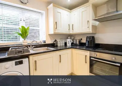 a kitchen with white cabinets and a sink at 2 Bed Shrewsbury Apartment in Great Location in Shrewsbury