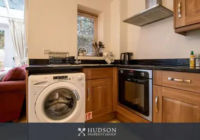 a kitchen with a dishwasher and a washing machine at Shrewsbury Apartment in Prime Location in Shrewsbury