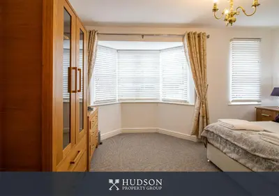 a bedroom with a bed and a window and a chandelier at Shrewsbury Apartment in Prime Location in Shrewsbury