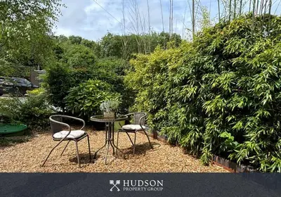 two chairs and a table in a garden at Beautiful Cottage in the Heart of Shrewsbury in Shrewsbury