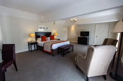 a hotel room with a bed and a chair at Albrighton Hall Hotel and Spa, a member of Radisson Individuals in Shrewsbury