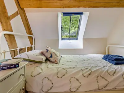 a bed in a room with a window at 5 Bed in Craven Arms oc-95212 in Tugford