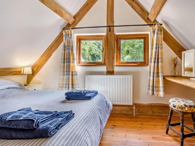 a bedroom with a bed and two windows at 5 Bed in Craven Arms oc-95212 in Tugford