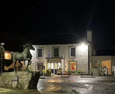 a statue of a horse in front of a building at Feathers Hotel Bar and Restaurant in Aberaeron