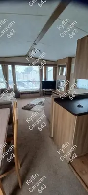 a living room with white writing on the floor at Kyffin 643 in Barmouth