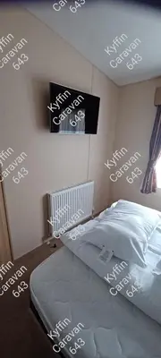 a bedroom with white writing on the wall at Kyffin 643 in Barmouth