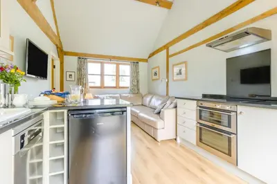 a kitchen with a stainless steel refrigerator and a couch at 2 Bed in Little Hereford oc-l29580 in Berrington