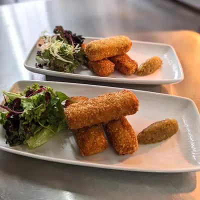 two plates of food with nuggets and a salad at The Castle Coaching Inn in Trecastle
