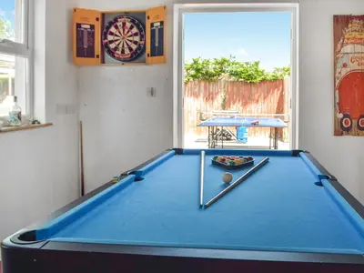 a blue pool table in a room with a dartboard at Ferwig in New Quay