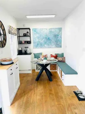a kitchen with a table in the middle of a room at Awelfa a peaceful cottage in the Cambrian mountains in Llanbrynmair