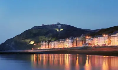 a building on the shore of a body of water at Abergwaun APT 1 in Aberystwyth