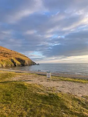 a sign on a beach near the ocean at Stunning Pet Friendly 2 bed StaticCaravan in Clarach Bay 2017 model in Aberystwyth