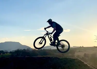 a man doing a trick on a bike in the air at MTB Jumps View Pod in Trawsfynydd
