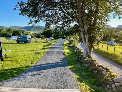 a gravel road with trees on the side of a field at MTB Jumps View Pod in Trawsfynydd