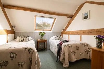 two beds in a attic bedroom with a roof at Tollant in Rhayader
