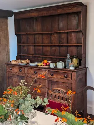 a large wooden cabinet with food on top of it at Maes Y Neuadd Country House in Talsarnau