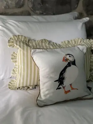 a pillow with a bird on it on a bed at Maes Y Neuadd Country House in Talsarnau