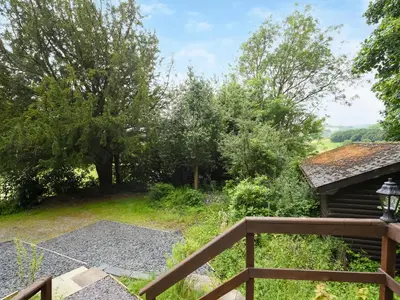 a view of the garden from the balcony of a house at The Squirrels Drey C32 - Uk45927 in Newtown