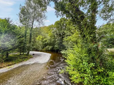 a river with trees on the side of it at The Squirrels Drey C32 - Uk45927 in Newtown