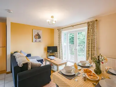a living room with a couch and a table at High Tide in Scyborycoed