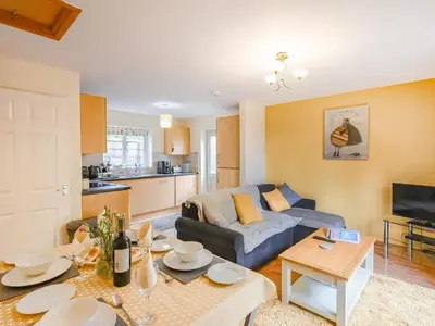 a living room with a couch and a table at High Tide in Scyborycoed