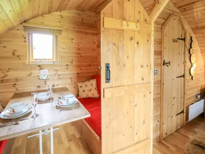 a room with a table in a wooden cabin at Oak View in Llangadog
