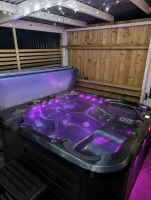a purple bathtub in a room with purple lighting at Synod Farm Cottage, 5 Person Hot Tub, Pets Welcome in Llandysul