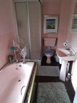 a bathroom with a tub and a sink and a toilet at Ty Gwyn Farmhouse in Brecon