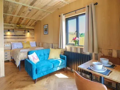 a living room with a couch and a bed at Rooster's Rest in Saint Harmon