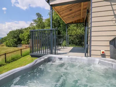 a hot tub in the backyard of a house at Rooster's Rest in Saint Harmon