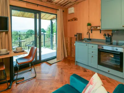 a kitchen with a view of a balcony at Rooster's Rest in Saint Harmon