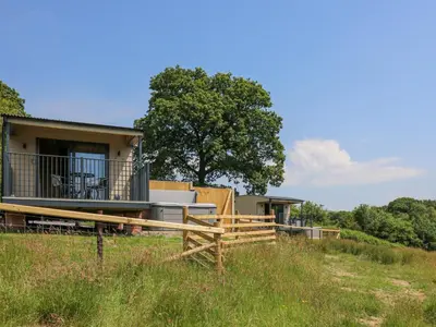 a house in the middle of a field at Rooster's Rest in Saint Harmon