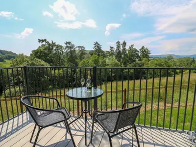 a table and two chairs on a balcony at Hen's Hideaway in Saint Harmon