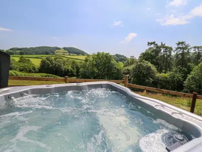 a jacuzzi tub with water in a yard at Hen's Hideaway in Saint Harmon